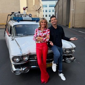 Ryan and Vanna in front of Ecto-1 from Ghostbusters. 
